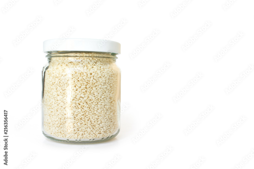 white sesame seed in jar on white background white sesame seed in jar on white background