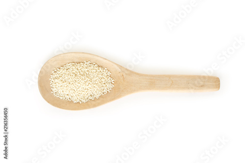 white sesame seeds in spoon on white backgroud