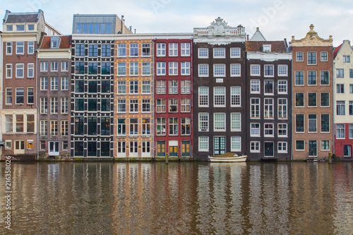 Traditional Dutch houses on the banks of the canal in the center of Amsterdam. Netherlands