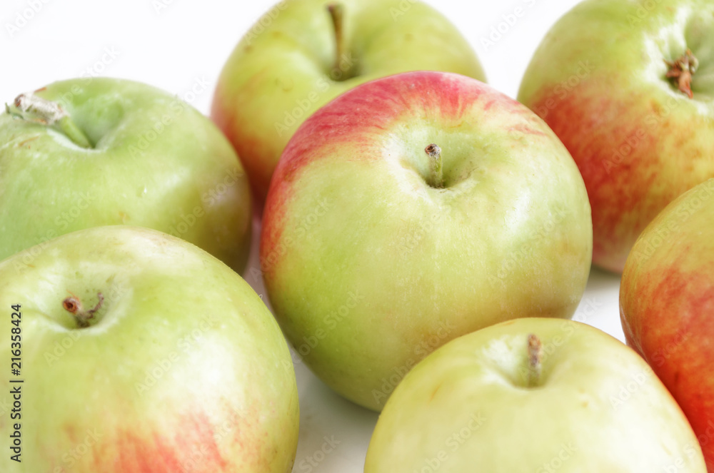 Green apples on a white background with a shadow. Green apples on a white background with a shadow.