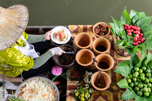 Market woman in boat cooking food at floating Market in Bangkok, Thailand photo