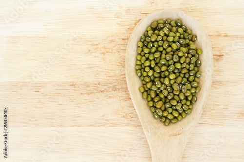 Fototapeta Naklejka Na Ścianę i Meble -  mung bean green in spoon texture on wood background