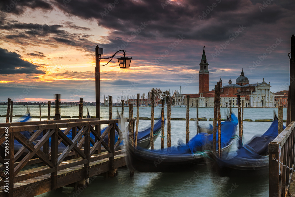 Gondolas docked with the island of San Giorgio Maggiore in the background