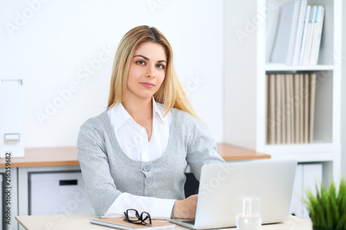 Young business woman or student girl working at office workplace with laptop computer © rogerphoto
