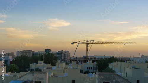 Construction on the building in Bin Omran area during sunset with workers operating a cement pump. photo