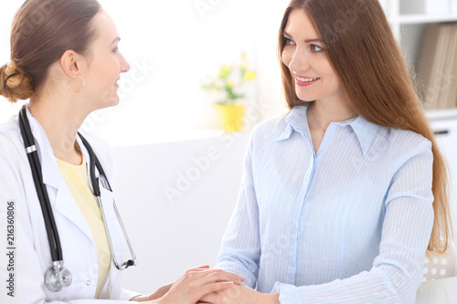 Wallpaper Mural Doctor and  patient  sitting at the desk near window Torontodigital.ca