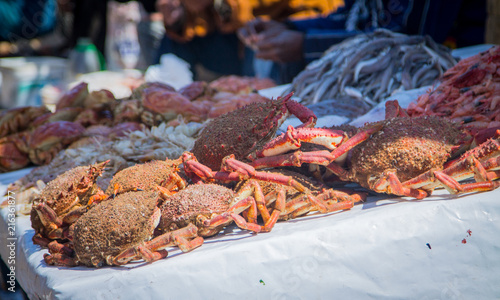 Counter with fresh sea products at the fish market in the port of the city of Essaouira. Slides of seafood. Morocco, Africa