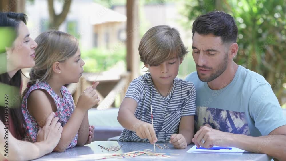 Happy family enjoying playing game together Happy family enjoying playing game together