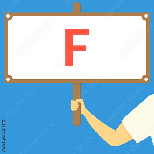 F. Hand holding wooden sign