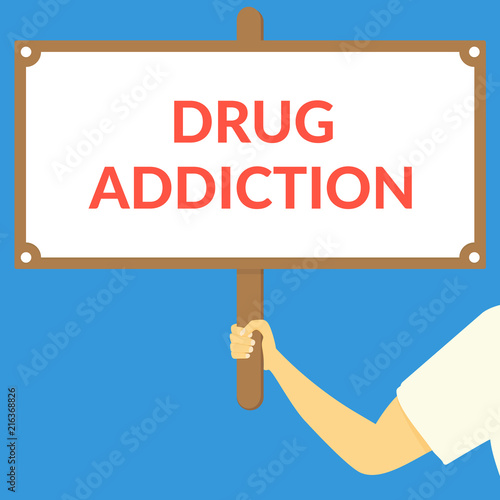 DRUG ADDICTION. Hand holding wooden sign