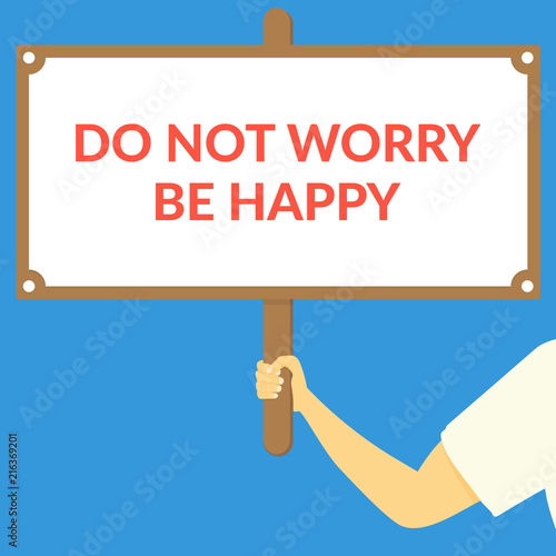 DO NOT WORRY BE HAPPY. Hand holding wooden sign