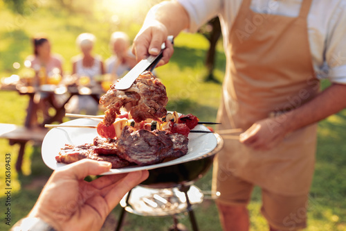 Obraz na płótnie Family grilling meat on a barbecue