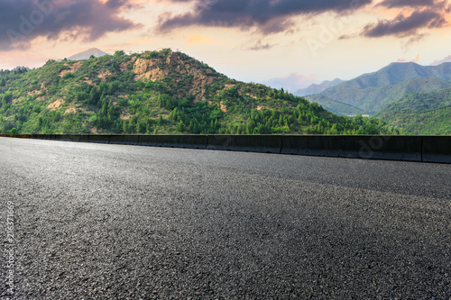 Asphalt highway and mountain natural landscape at sunrise © ABCDstock