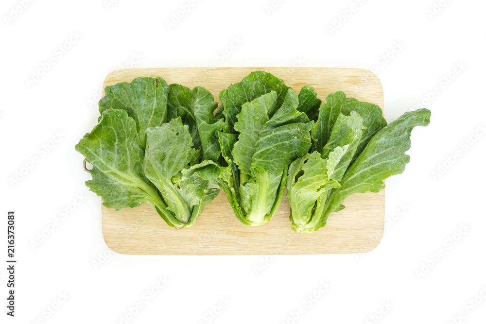 chinese kale on cutting board top view on white background chinese kale on cutting board top view on white background