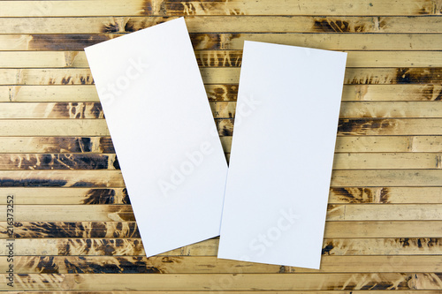 Blank flyer over bamboo background to replace your design.