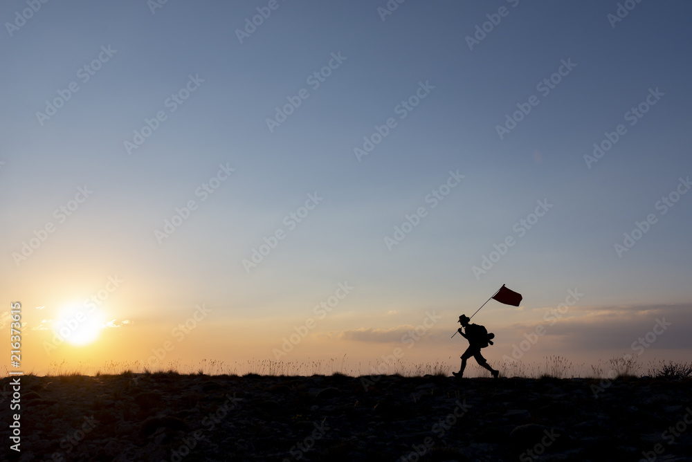 Brave mountaineer carrying the flag on top Brave mountaineer carrying the flag on top