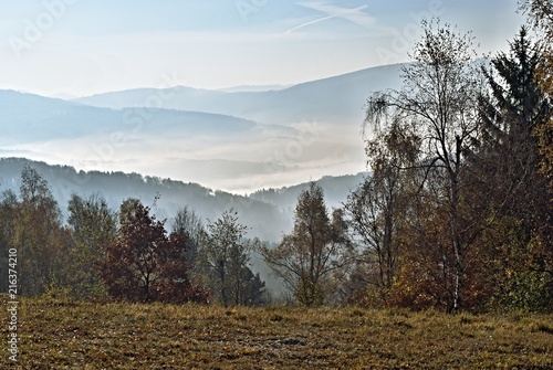 Autumn landscape with fog and hills on the horizon