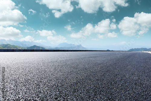 Asphalt road and beautiful mountain scenery under the blue sky