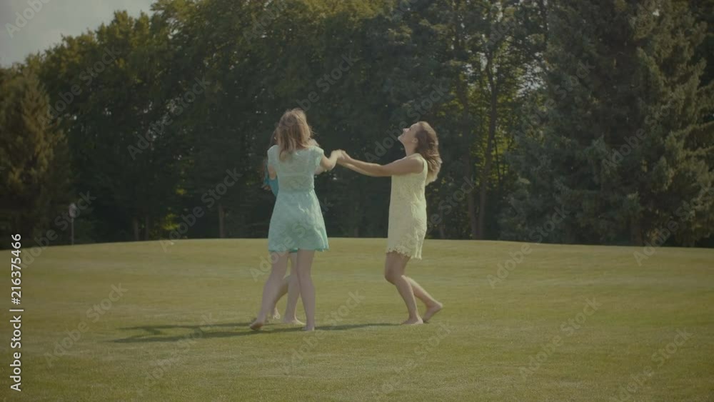Video Stock Positive smiling barefoot best female freinds holding hands ...