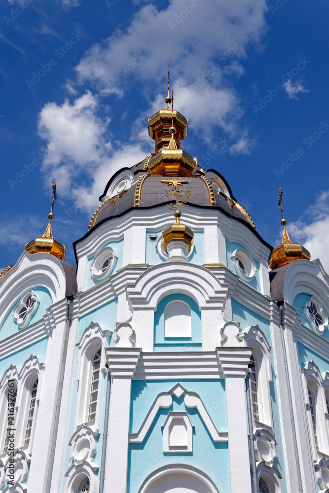 Orthodox temple of saint Alexander in city Kharkiv (Ukraine). Temple in a bright sunny summer day on a blue sky background.