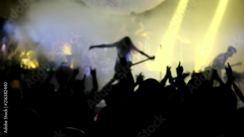 Rock star acclamation at music concert event. Heavy metal band performs a rock concert at the club. the artist bows to the audience photo