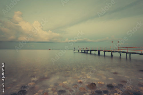 Beautiful seascape with coast line. Tropical Resort. Jetty on sunset beach. Turkey. Long exposure shot.