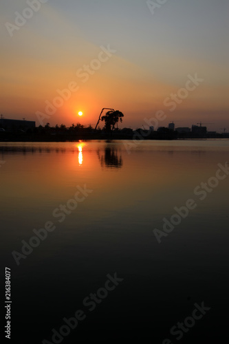 sunset on the water in a park