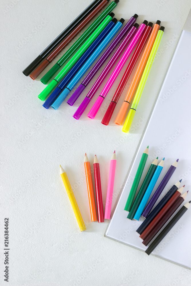 Accessories for children's art pencils, markers and album on a white background. Accessories for children's art pencils, markers and album on a white background.