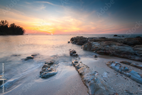 Wallpaper Mural view of beautiful sunset at the beach with natural coastal rocks covered by green moss. soft focus due to slow shutter effect. Torontodigital.ca