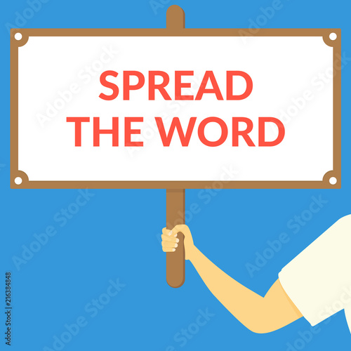 SPREAD THE WORD. Hand holding wooden sign