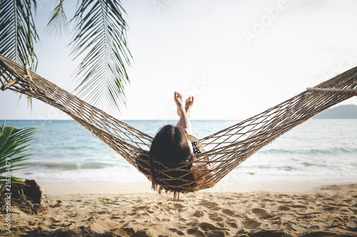 Happy woman relaxing in hammock photo