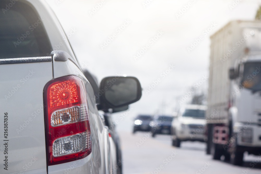 White pick up car on the road break for stop by traffic light control with cross the road across. White pick up car on the road break for stop by traffic light control with cross the road across.