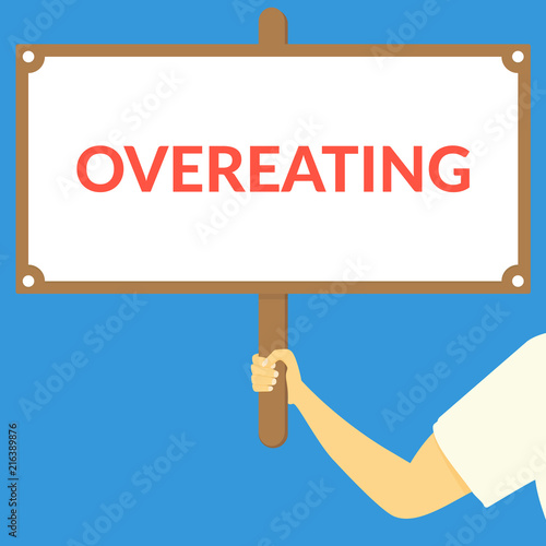 OVEREATING. Hand holding wooden sign