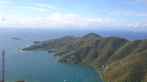 Normal-paced drone flight towards the island of St. John, overlooking sailboats and hilly terraine photo