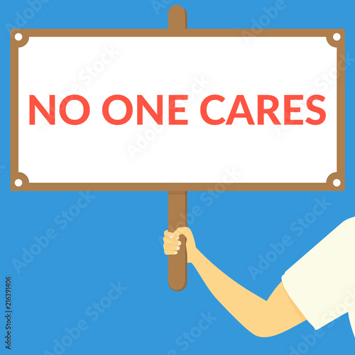 NO ONE CARES. Hand holding wooden sign
