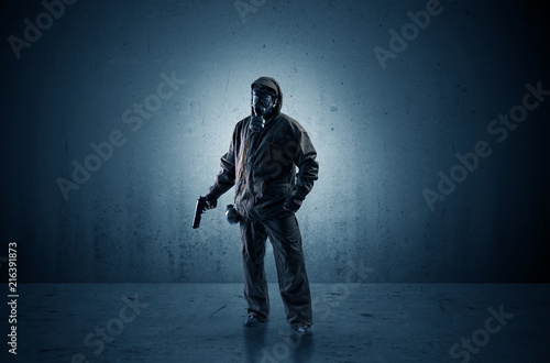 Bad agent in a dark room with arms on his hand and gas mask 