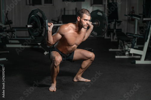 Male training with barbell, pumping legs