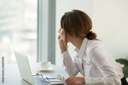 Bild auf Leinwand Happy businesswoman looking far away in window, dreaming about future, feeling motivated in office, thoughtful woman smiling imagining bright perspectives, thinking about new job or business success