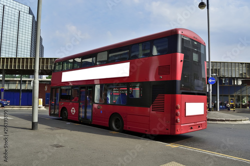 Double Decker red bus is running on road in London © suman