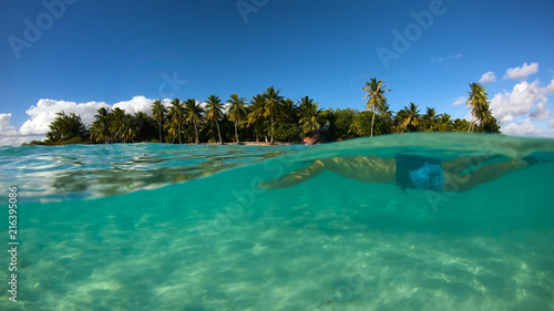 a couple doing snorkeling in a lagoon in French Polynesia