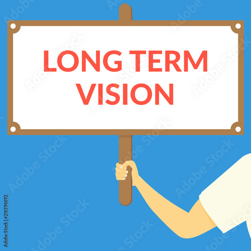 LONG TERM VISION. Hand holding wooden sign