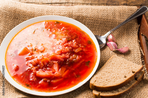 Homemade soup - Borscht of beetrot, vegetables and meat with sour cream photo