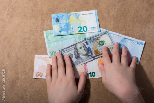 Hand holding American dollar  isolated on wooden background photo