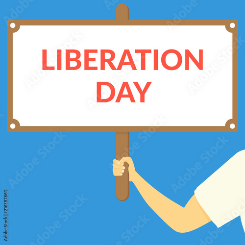 LIBERATION DAY. Hand holding wooden sign