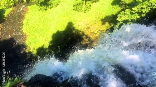 River falls in slow motion over the edge forming a waterfall Fuipisia waterfall in Samoa photo