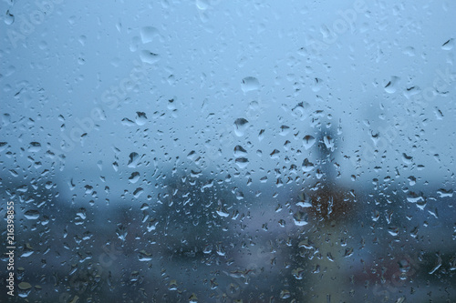 season rains drops on glass window