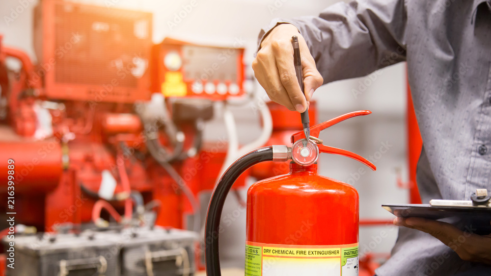 Engineer inspection Fire extinguisher in control room. Engineer inspection Fire extinguisher in control room.