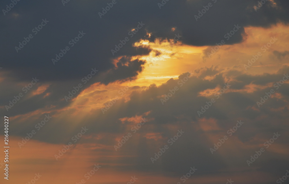 sunlight spreading through dark cloud in evening sunlight spreading through dark cloud in evening