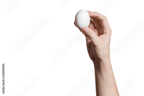 Hand holding an egg, isolated on white background