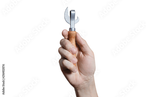 Hand holding a can opener, isolated on white background